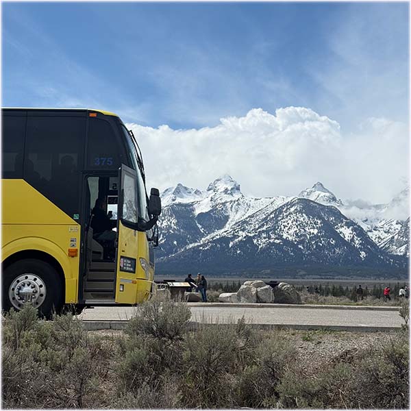 GrandTetonStepOnTourGuideImage Guides of Jackson Hole The front of a tour coach with the snowy Teton Range in the background